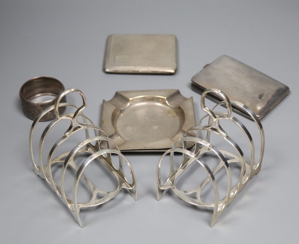 Small silver and other items including a pair of toast racks, four knife rests, ashtrays, 19th century wine label etc.